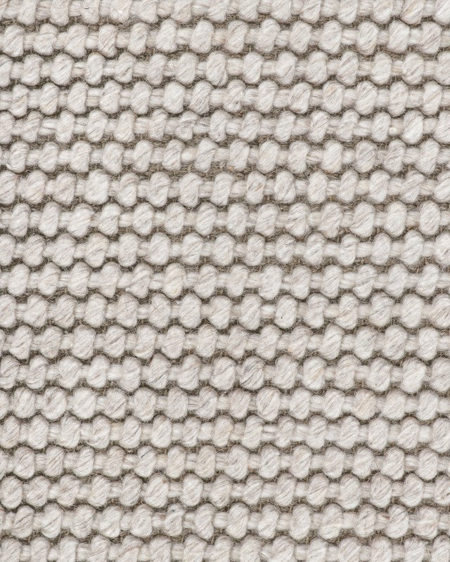 Handwoven beige Cyrus Earth rug, measuring 250x350cm, featuring a knotted weave and soft texture, perfect for any decor.