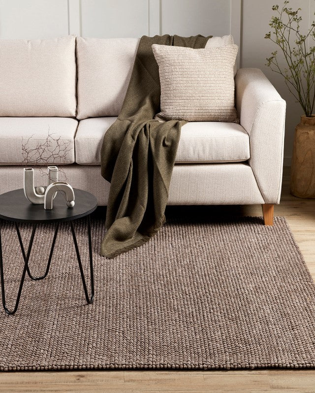 Luxurious handwoven floor rug in warm beige, 250x350cm, crafted from wool, cotton, and polyester for durability and comfort.