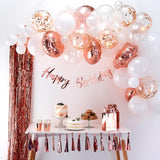 Elegant rose gold and white balloon arch kit with confetti balloons, perfect for celebrations and photo backdrops.