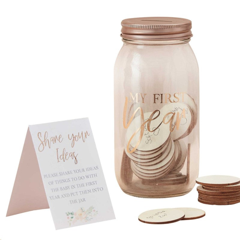 Stylish glass memory jar with 50 customizable tokens for capturing baby's first-year milestones and memories.