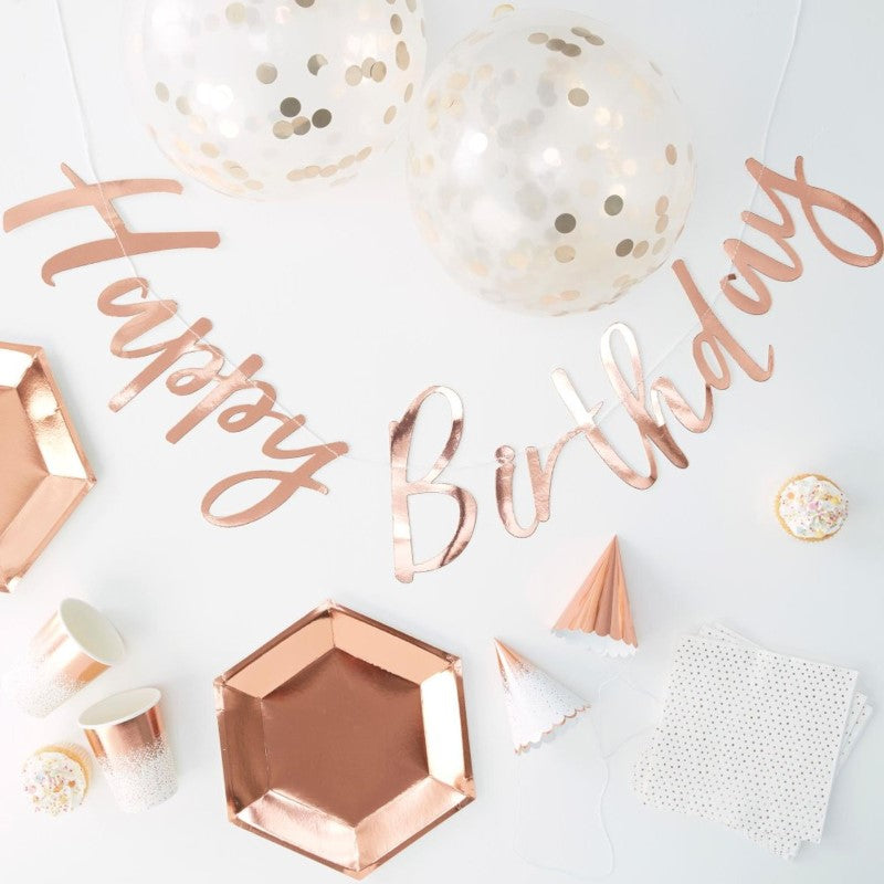 Rose Gold Foiled Party In A Box featuring elegant plates, cups, napkins, party hats, balloons, and bunting for stylish celebrations.