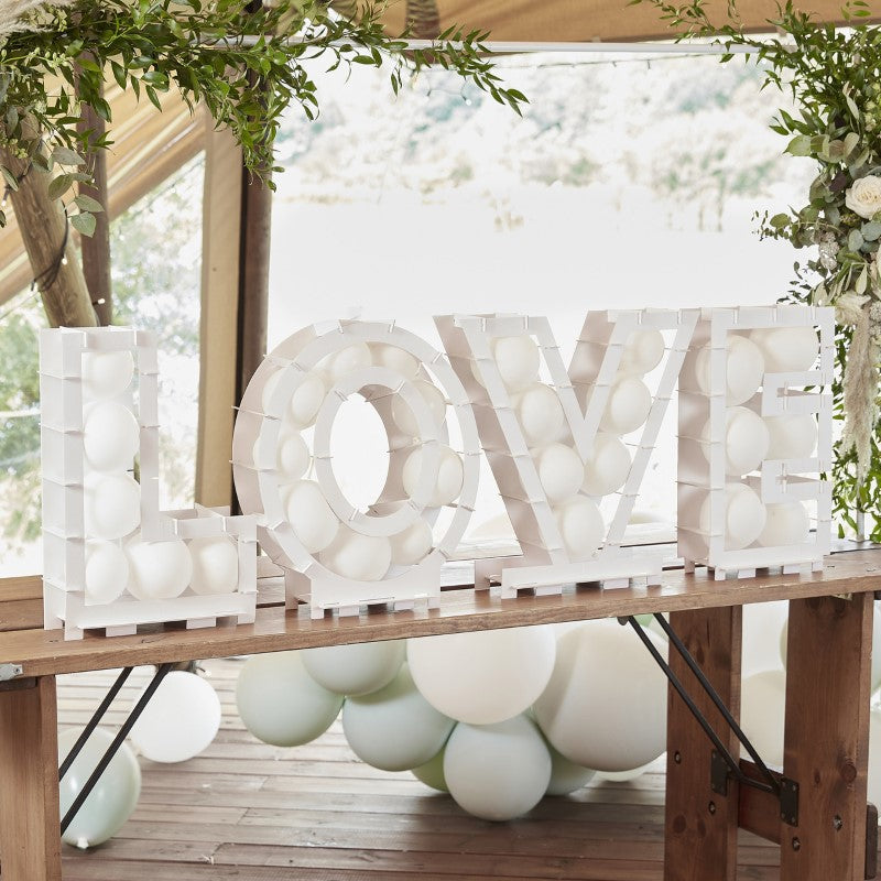 Botanical Wedding Balloon Mosaic L-O-V-E display, featuring sturdy cardboard letters, perfect for enchanting wedding decor.