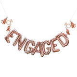 Rose gold "ENGAGED" balloon bunting kit with tassels and rings, perfect for engagement parties and celebrations of love.