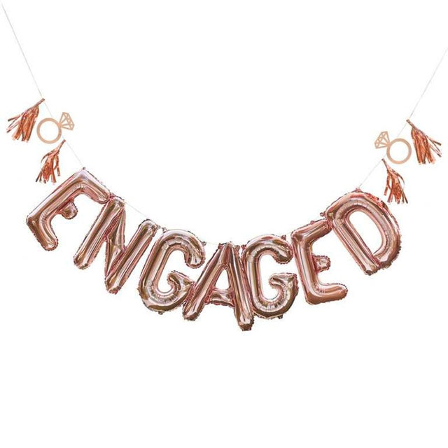 Rose gold "ENGAGED" balloon bunting kit with tassels and rings, perfect for engagement parties and celebrations of love.