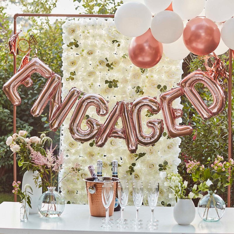 Engaged balloon bunting in rose gold with tassels and rings, perfect for celebrating engagements with style.