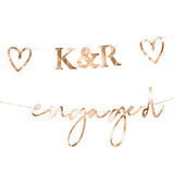 Engaged bunting in rose gold, customizable initials & hearts, perfect for engagement celebrations and decorations.