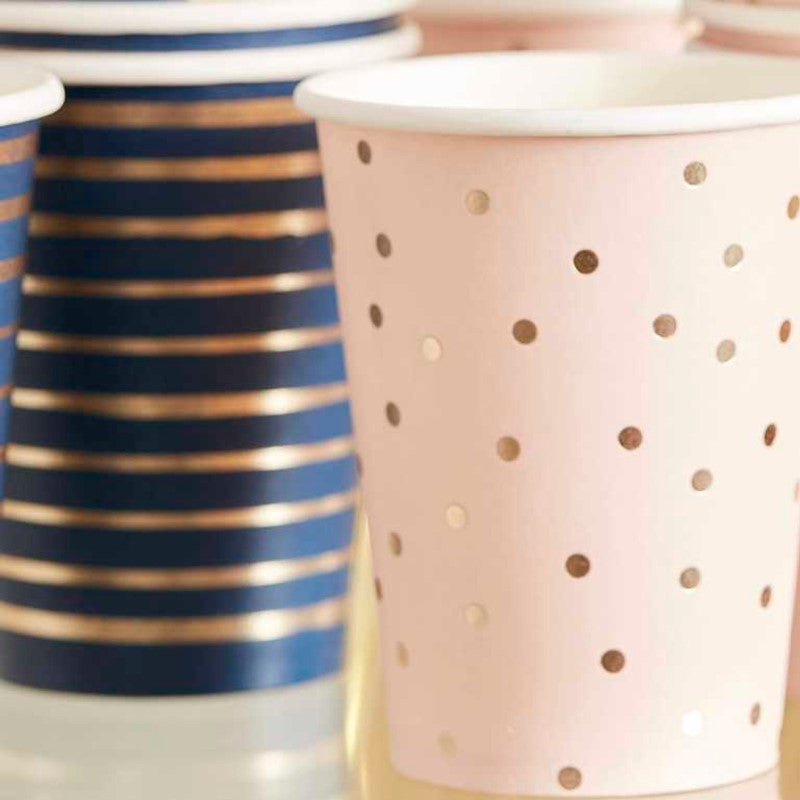 Gender reveal party cups featuring pink dots and blue stripes with gold foil accents, perfect for celebrations. Pack of 8.