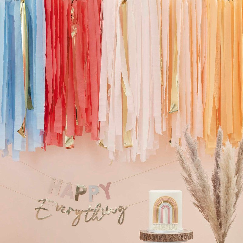 Muted pastel rainbow ceiling steamers for vibrant party decoration, featuring 200m of colorful crepe and gold accents.