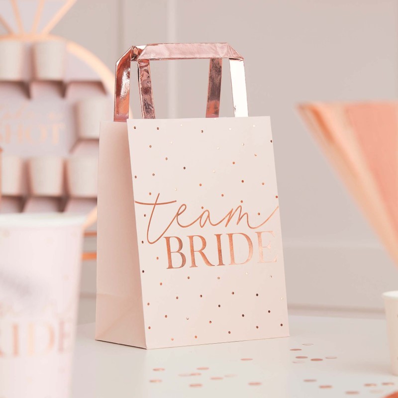 Pink Team Bride rose gold foiled hen party bags, stylish pack of 5 for bachelorette essentials, measuring 27cm x 14.5cm.