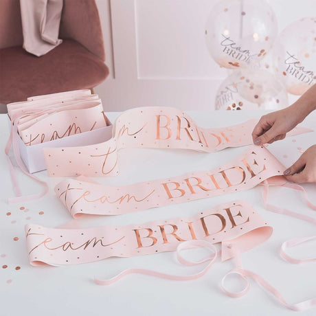 Pink and rose gold "Team Bride" sashes for hen parties, pack of 6, adding elegance and fun to Bachelorette celebrations.