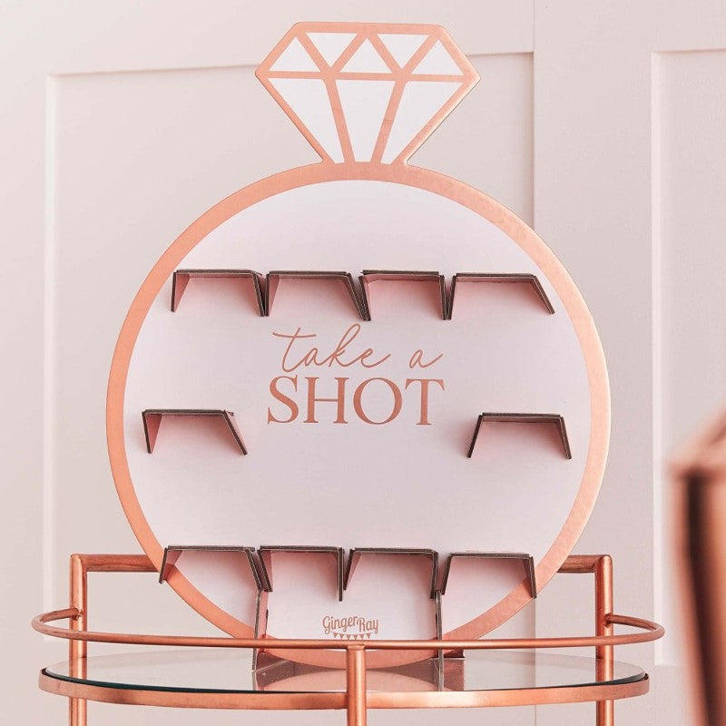 Rose gold drinks shot wall for hen parties, featuring 10 holders on a stylish cardboard backdrop, measuring 40cm x 69cm.