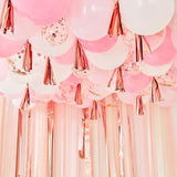 Mix It Up blush, white, and rose gold ceiling balloons with tassels and streamers, perfect for elegant celebrations and decor.