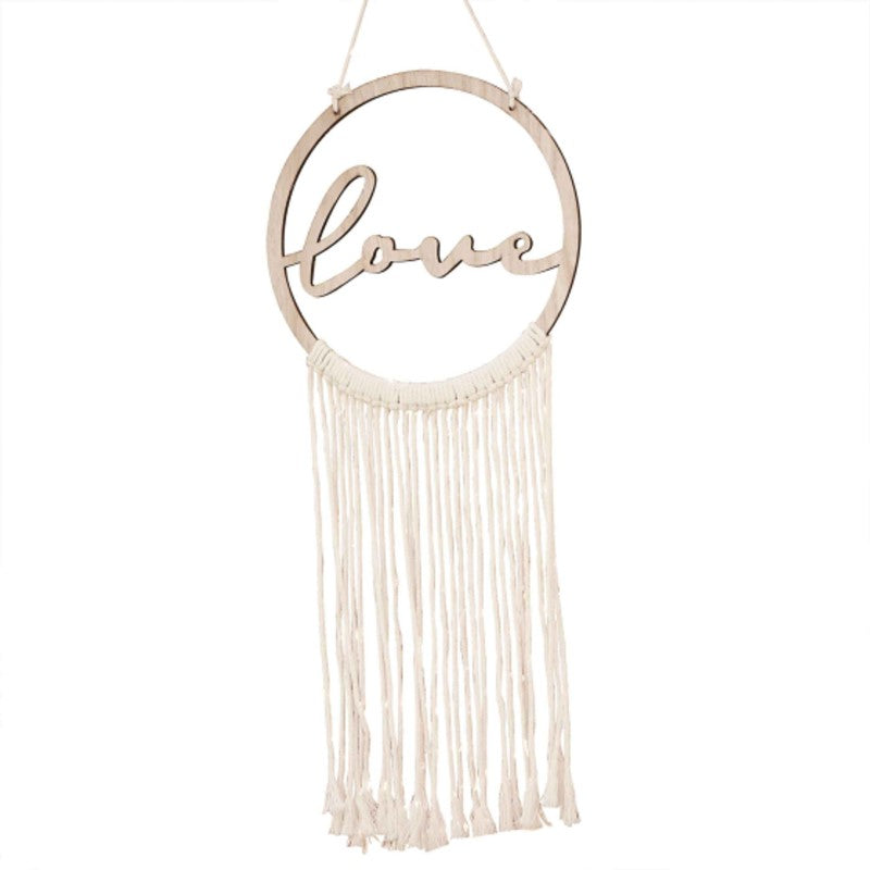 Boho-style wooden hoop with 'Love' script and cotton macrame, perfect for weddings and home decor.