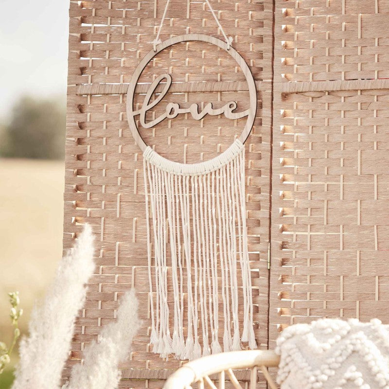 Boho-style wooden hoop with white macrame, featuring 'Love' script, perfect for weddings and home decor.