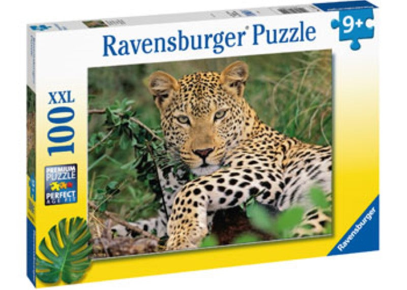 Colorful 100-piece puzzle featuring a lounging leopard among lush foliage, ideal for young wildlife enthusiasts.