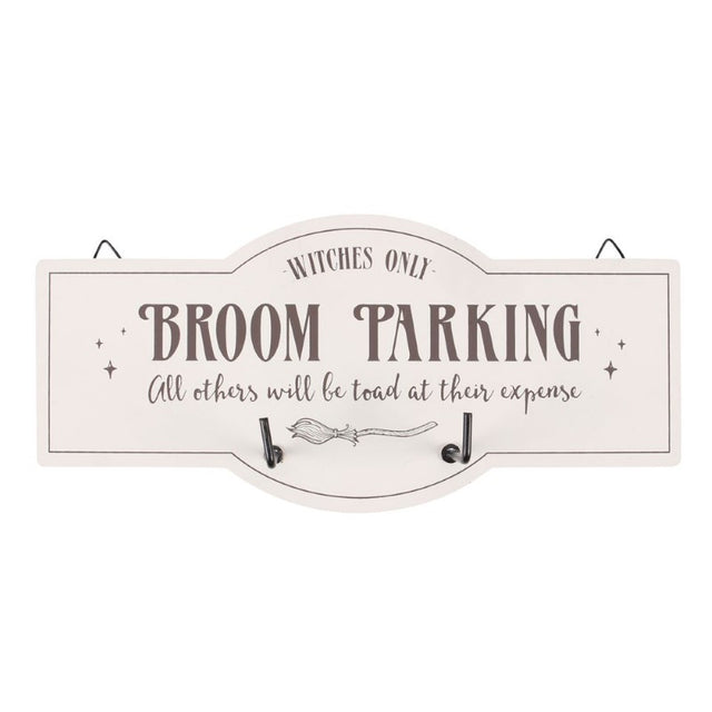 Whimsical wall hook sign with broom illustration and text 'Witches Only - Broom Parking' for organized witchy decor.