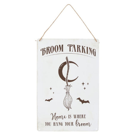 Whimsical metal sign featuring a broom illustration and 'Home is where you hang your broom' text for witchy decor.