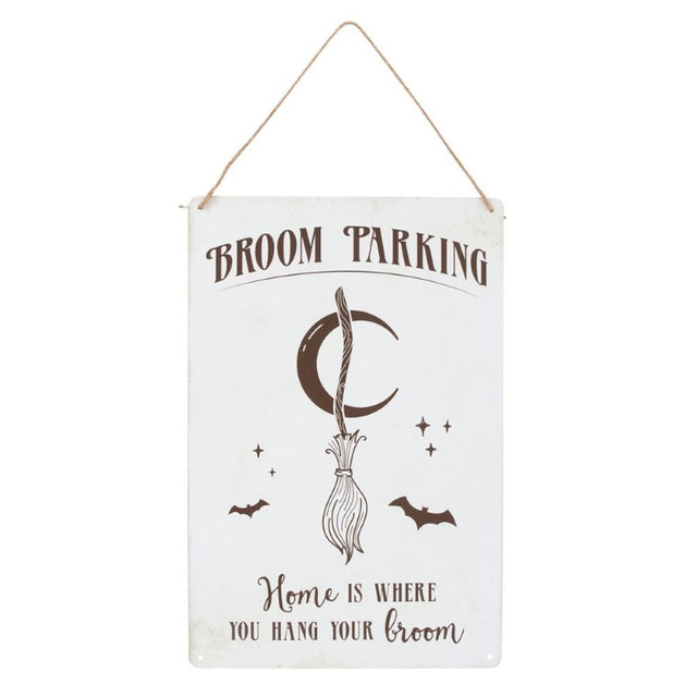 Whimsical metal sign featuring a broom illustration and 'Home is where you hang your broom' text for witchy decor.