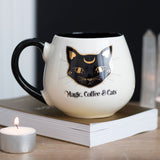 Ceramic mug featuring a mystical black cat and 'Magic, Coffee & Cats' text, perfect for cat lovers and coffee enthusiasts.