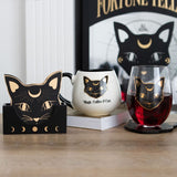 Ceramic mug featuring a mystical black cat and gold accents, perfect for cat lovers and coffee enthusiasts.