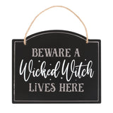 Whimsical Halloween sign reading "Beware a Wicked Witch Lives Here," ideal for decorating doors and entryways.
