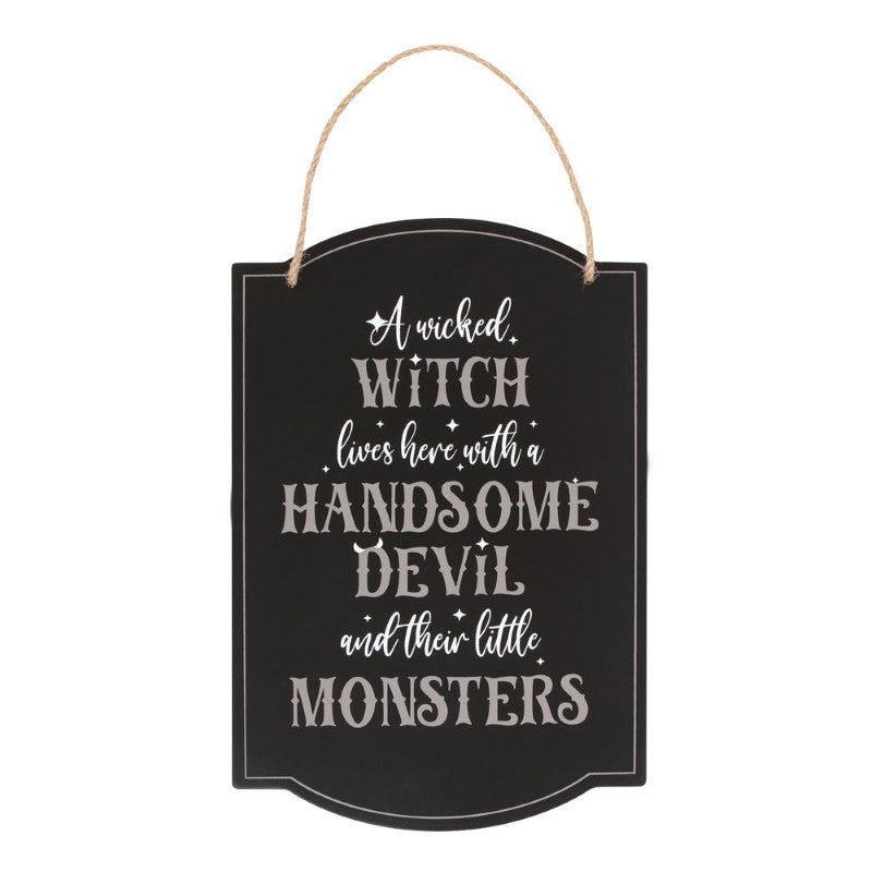 Whimsical hanging sign reading 'A Wicked Witch Lives Here' with spooky design, perfect for Halloween family decor.