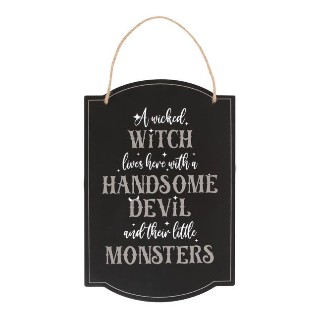 Whimsical hanging sign reading 'A Wicked Witch Lives Here' with spooky design, perfect for Halloween family decor.