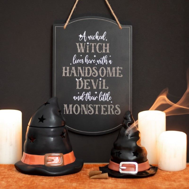 Whimsical Halloween sign reading "A Wicked Witch Lives Here" with playful designs, ideal for family-friendly decor.