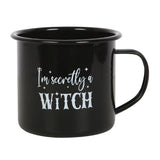 "I'm Secretly A Witch Enamel Mug" with whimsical text on a sleek black base, perfect for hot beverages and witchy vibes.