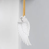 Delicate angel wing ornament with gold ribbon, celebrating friendship, perfect for home decor or thoughtful gifting.