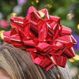 Red bow Christmas headband for adults and kids, perfect for festive celebrations and holiday gatherings.