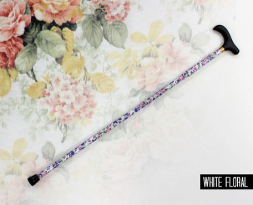 Folding walking stick with white floral design, adjustable height 33-37 inches, compact and stylish for mobility support.