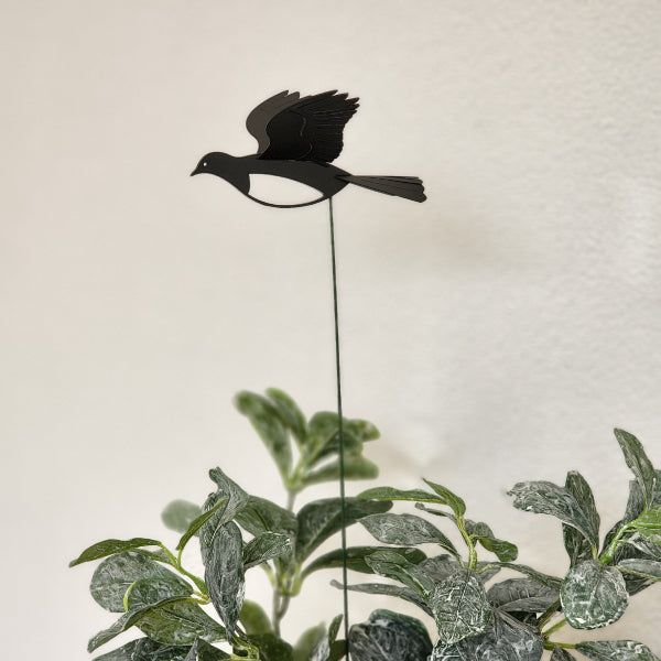 Mini Kereru plant stake with 3D wings, crafted from durable acrylic, enhances indoor and outdoor greenery with whimsical charm.