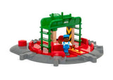 Wooden BRIO railway turntable with rotating center and poseable figure, featuring seven track connections for imaginative play.