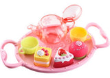 Colorful floating tea party set for bath time, featuring cups, cake squirters, and a shape sorting tray for imaginative play.