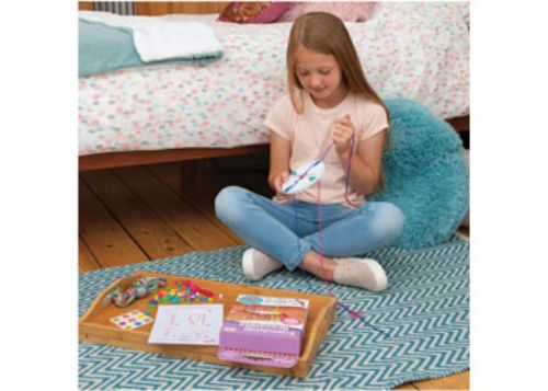 Colorful DIY craft kit for kids to create friendship bracelets, hair braids, and chokers with threads, beads, and ribbons.