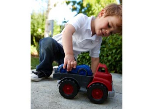 Eco-friendly Green Toys flatbed truck in blue with a red race car, designed for imaginative play and safe for toddlers aged 1+.