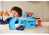 Colorful Green Toys Parking Garage with ramps, elevators, and a mini helicopter, promoting imaginative eco-friendly play for kids 3+.