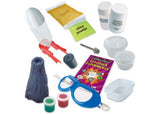 Kids' science kit featuring a rocket, volcano, slime ingredients, and goggles for fun, hands-on experiments.