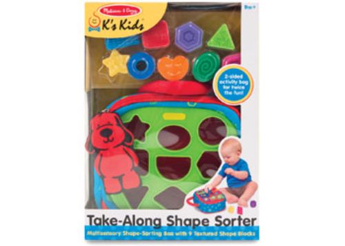 Colorful portable shape sorter with nine blocks, crinkly flaps, and a plush dog, designed for sensory play and learning.