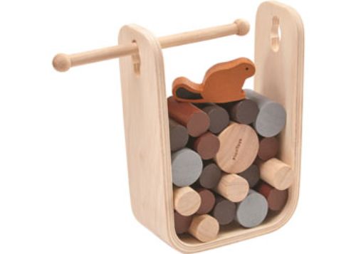 Children and adults taking turns playing PlanToys Timber Tumble, carefully pushing logs to save the beaver.