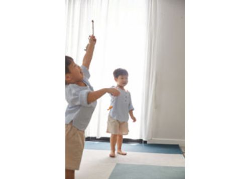 Colorful wooden fishing game with a magnetic rod, promoting fine motor skills and cooperative play for young children.