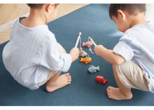 Wooden fishing game with magnetic rod and colorful fish, promoting fine motor skills and cooperative play for young children.