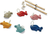 Colorful wooden fish and magnetic rod in PlanToys Fishing Game, promoting fine motor skills and cooperative play for kids.