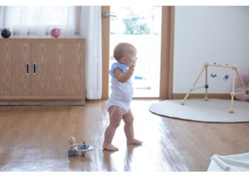 Colorful wooden Pull-Along Musical Bear that plays melodies, encourages movement, and enhances motor skills for toddlers.