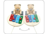 Wooden pull-along musical bear toy designed for toddlers, promoting play, movement, and motor skill development.