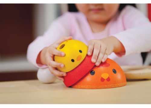 Colorful wooden chickens and eggs for toddlers, designed for stacking and sorting while promoting fine motor skills.