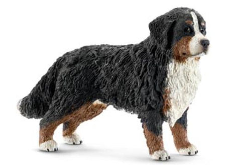 Schleich Bernese Mountain Dog figurine, featuring a friendly pose with distinctive black, brown, and white markings, ideal for play or collection.