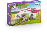 Schleich Riding Centre featuring vibrant green doors, pink windows, horses, a leisure rider, and movable roof for imaginative play.