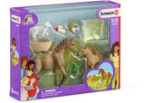 Schleich playset featuring a hand-painted Quarter horse foal and Sarah caring for a puppy, promoting animal care and imaginative play.